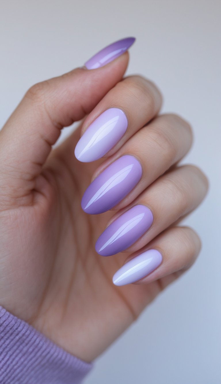 A feminine hand with glossy almond nails showing ombre nail art ideas in a lilac-to-purple gradient, blending sophistication with soft edge.