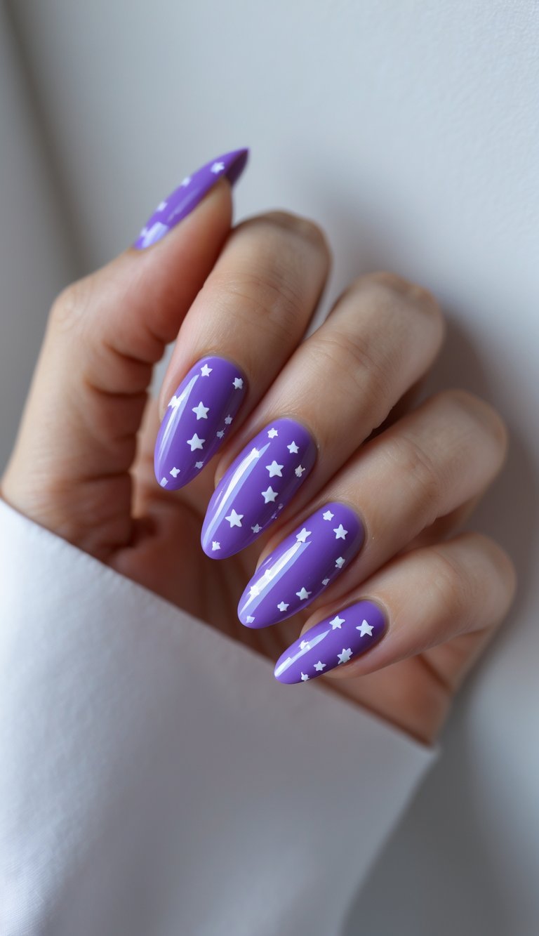 A hand rests near a white surface, showcasing a purple and white nail art idea with shiny lavender nails decorated with scattered white star accents.