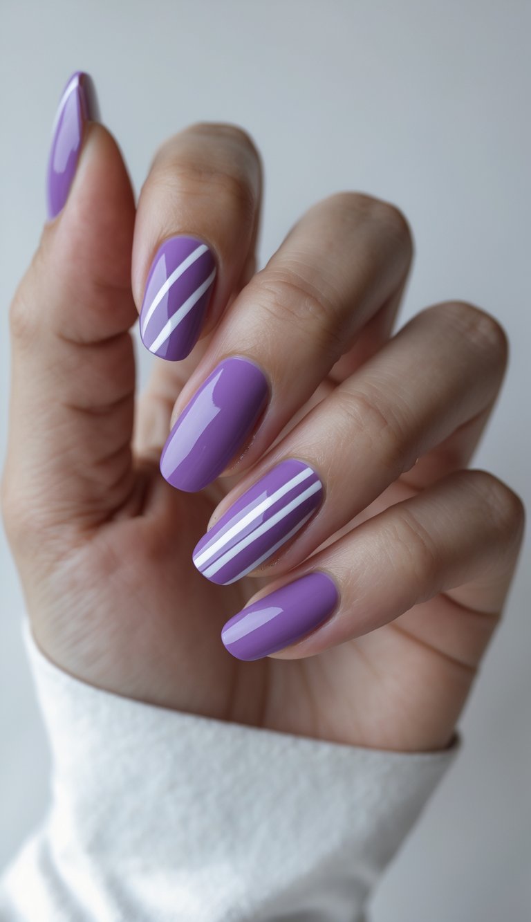 Fingers shown close-up wearing glossy lavender nails with minimal white line designs, illustrating a stylish purple and white nail art idea.