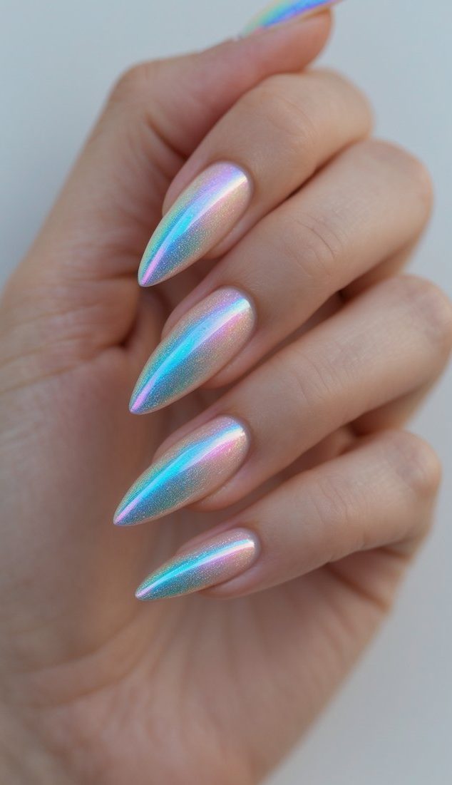 Editorial-style hand pose featuring an iridescent nail art idea with tapered almond nails and a luminous rainbow chrome finish across each nail.