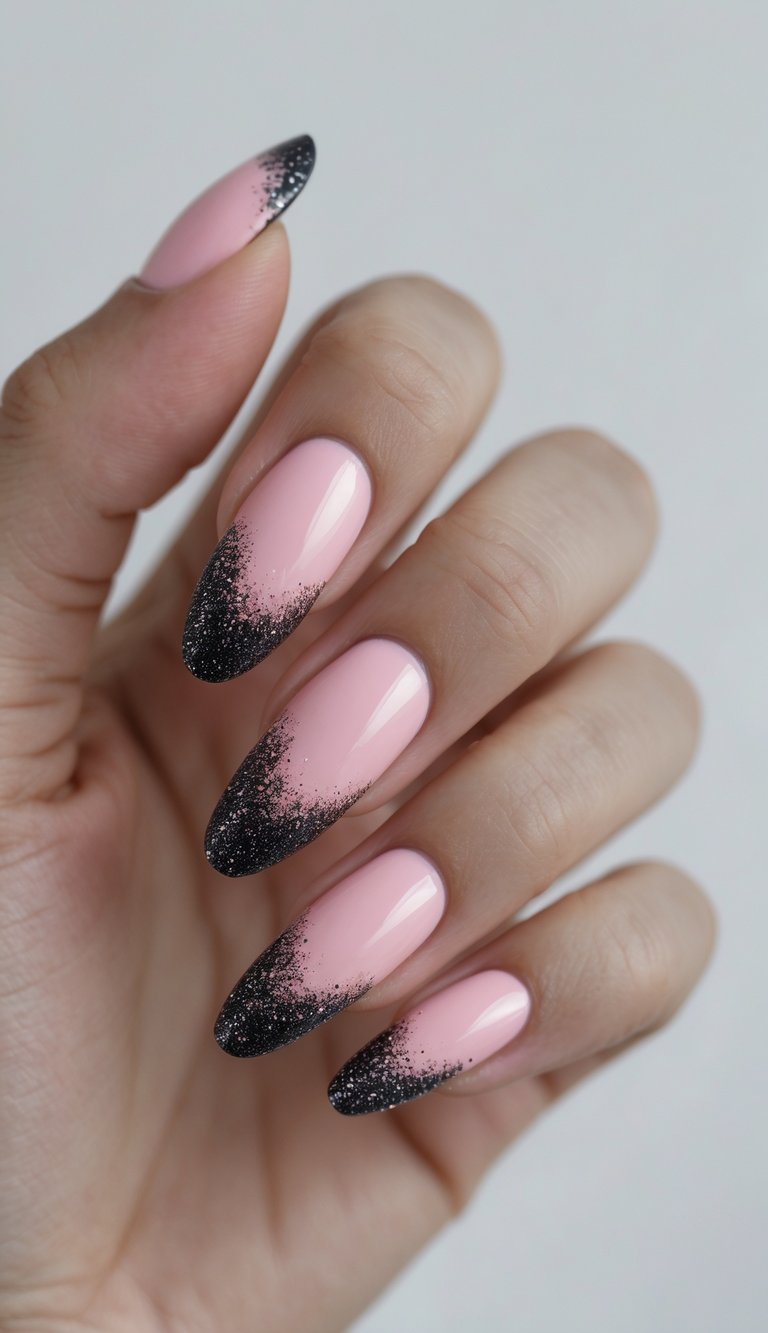 Close-up of one hand showing nails with pink base and black glitter French tips against a white background.