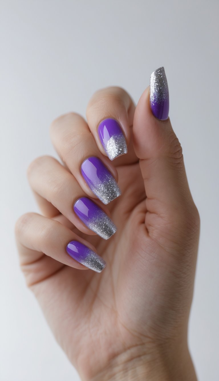 Close-up of one hand with purple nails and silver glitter gradient tips against a white background.