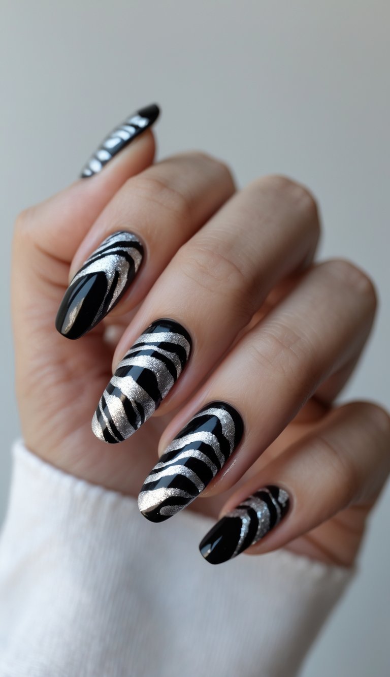 Close-up of one hand with silver zebra print nail art on jet black nails against a white background.