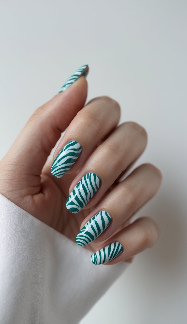 Close-up of one hand with teal zebra print nail art on a white background.