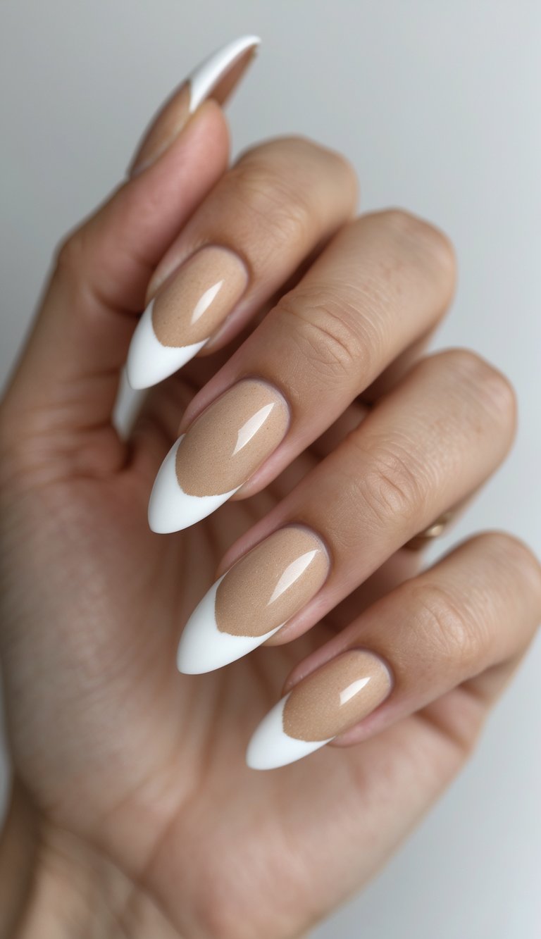 Close-up of one hand showing almond-shaped nails painted sandy beige with white tips against a white background.