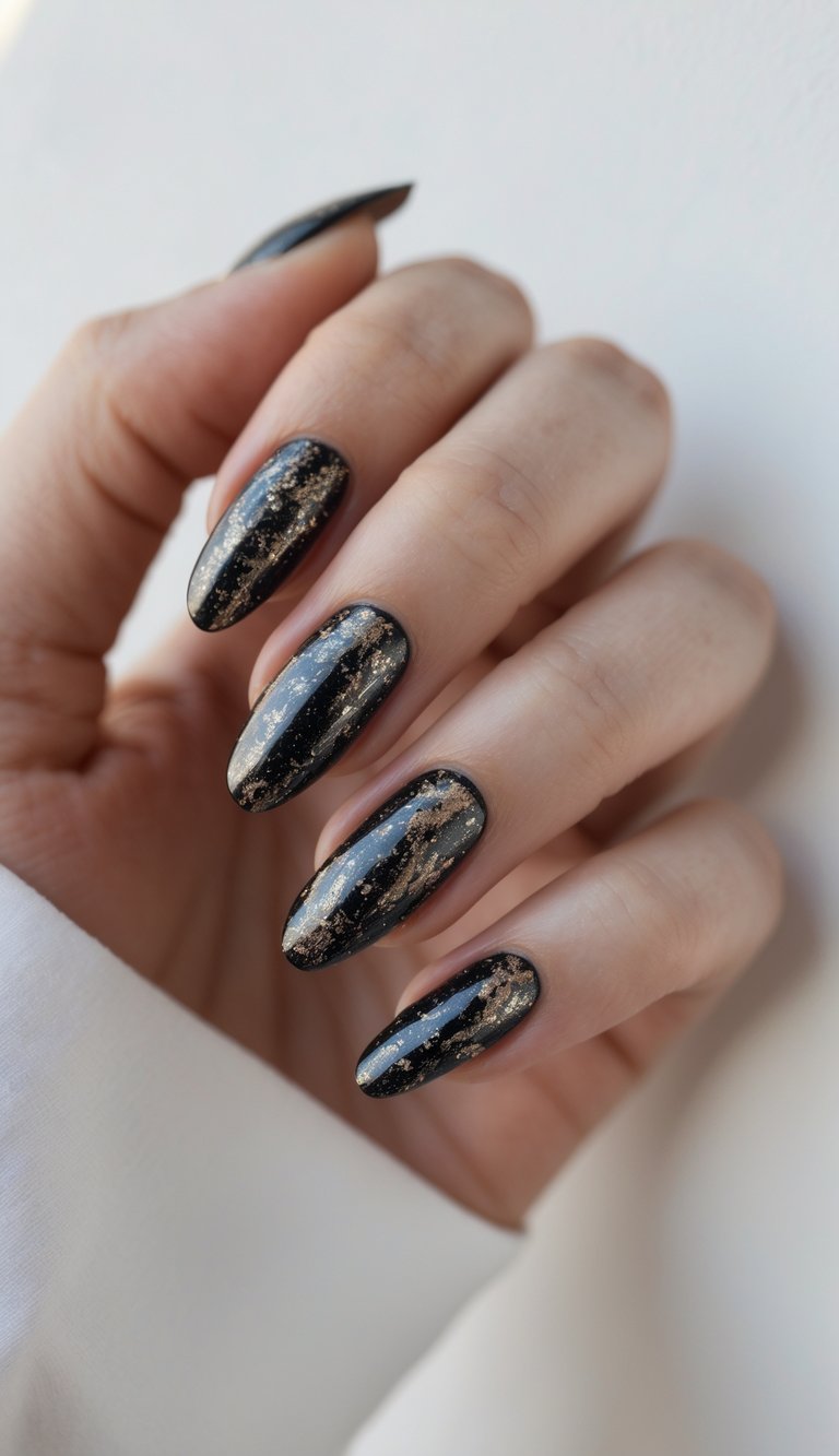 Close-up of one hand with black and glittery nails against a white background.