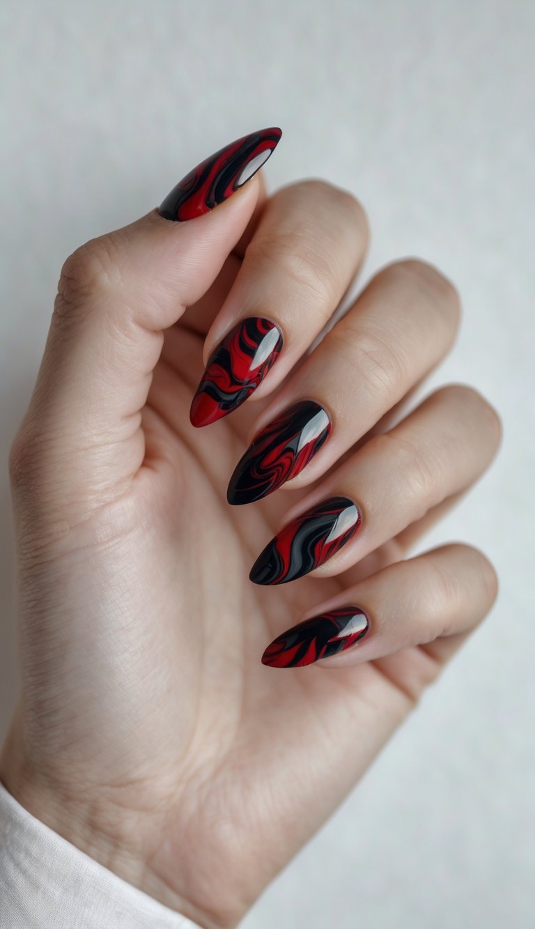 Close-up of one hand showing blood red and black marble patterned nails against a white background.