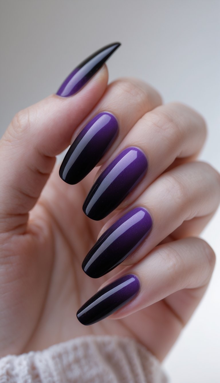 Close-up of a single hand with purple and black gradient nails against a white background.