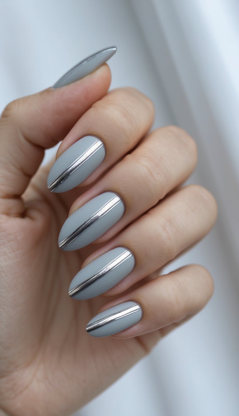 Close-up of one hand with light grey nails featuring thin metallic silver lines on a white background.