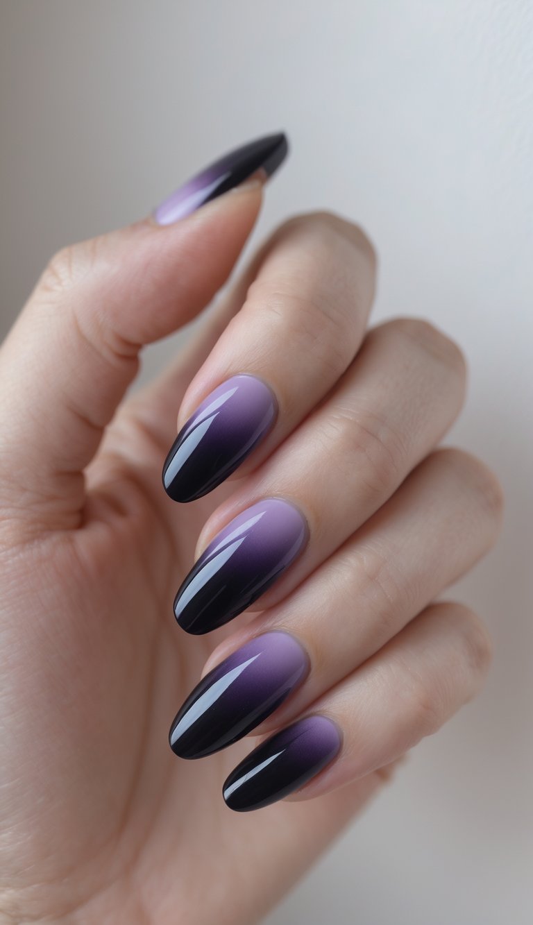 Close-up of one hand with dark purple to black ombre nails against a white background.
