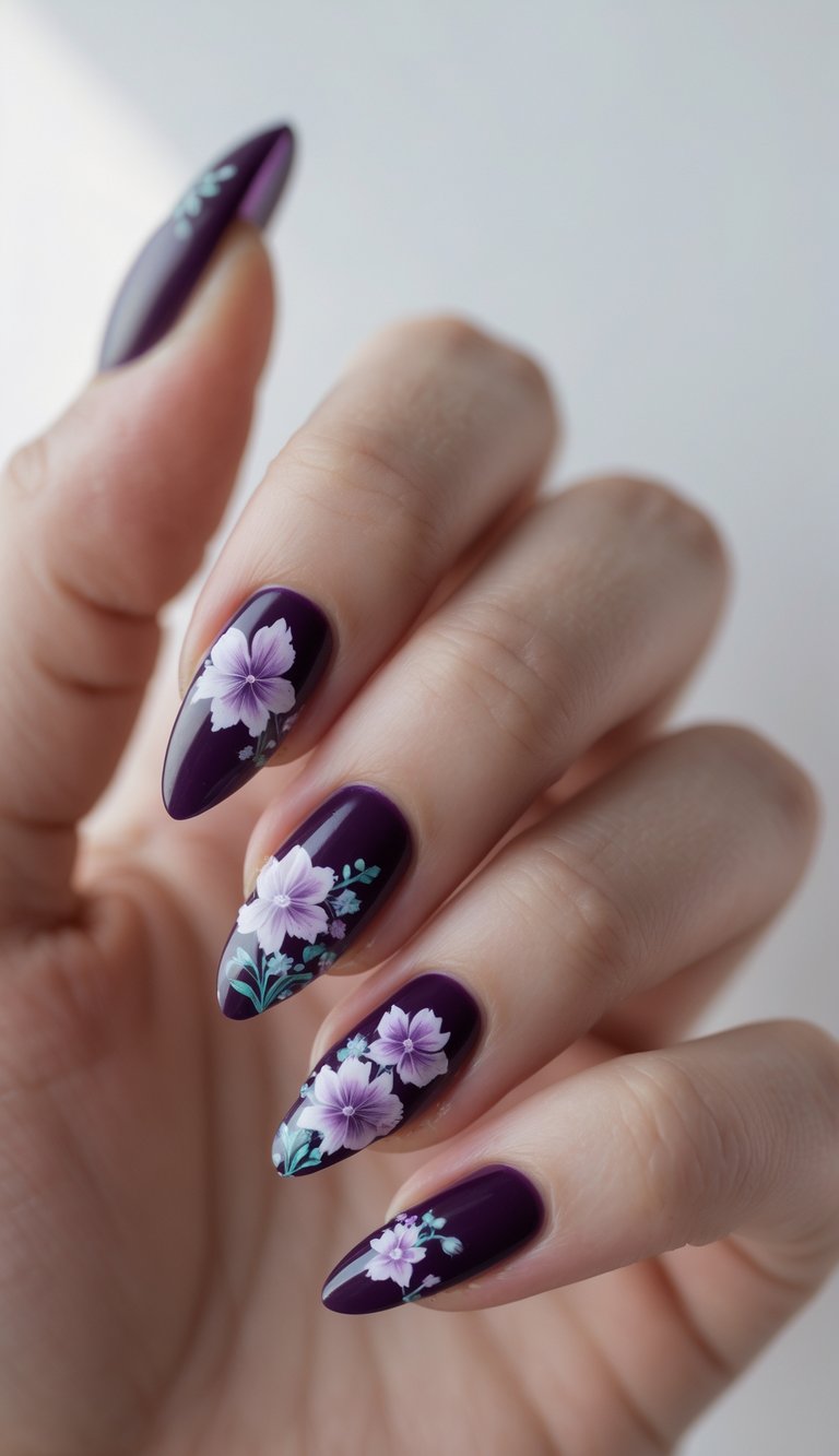 Close-up of a hand with deep purple nails decorated with floral designs against a white background.