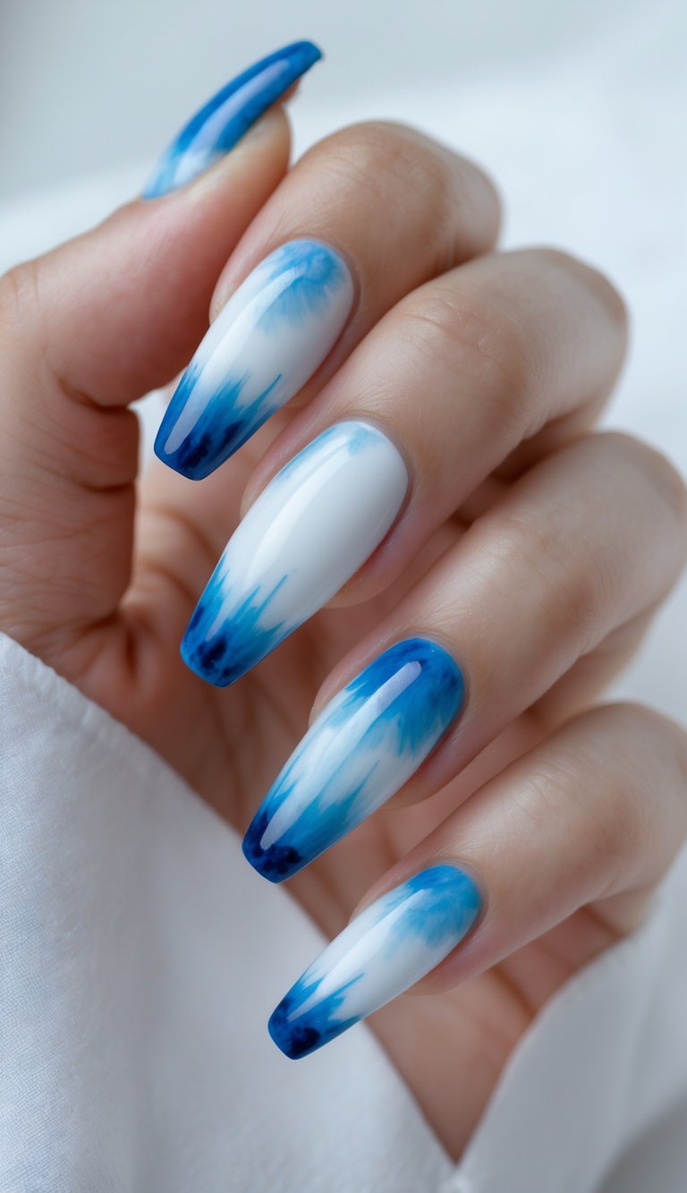 Close-up of one hand showing blue and white tie-dye patterned ballerina-shaped nails against a white background.