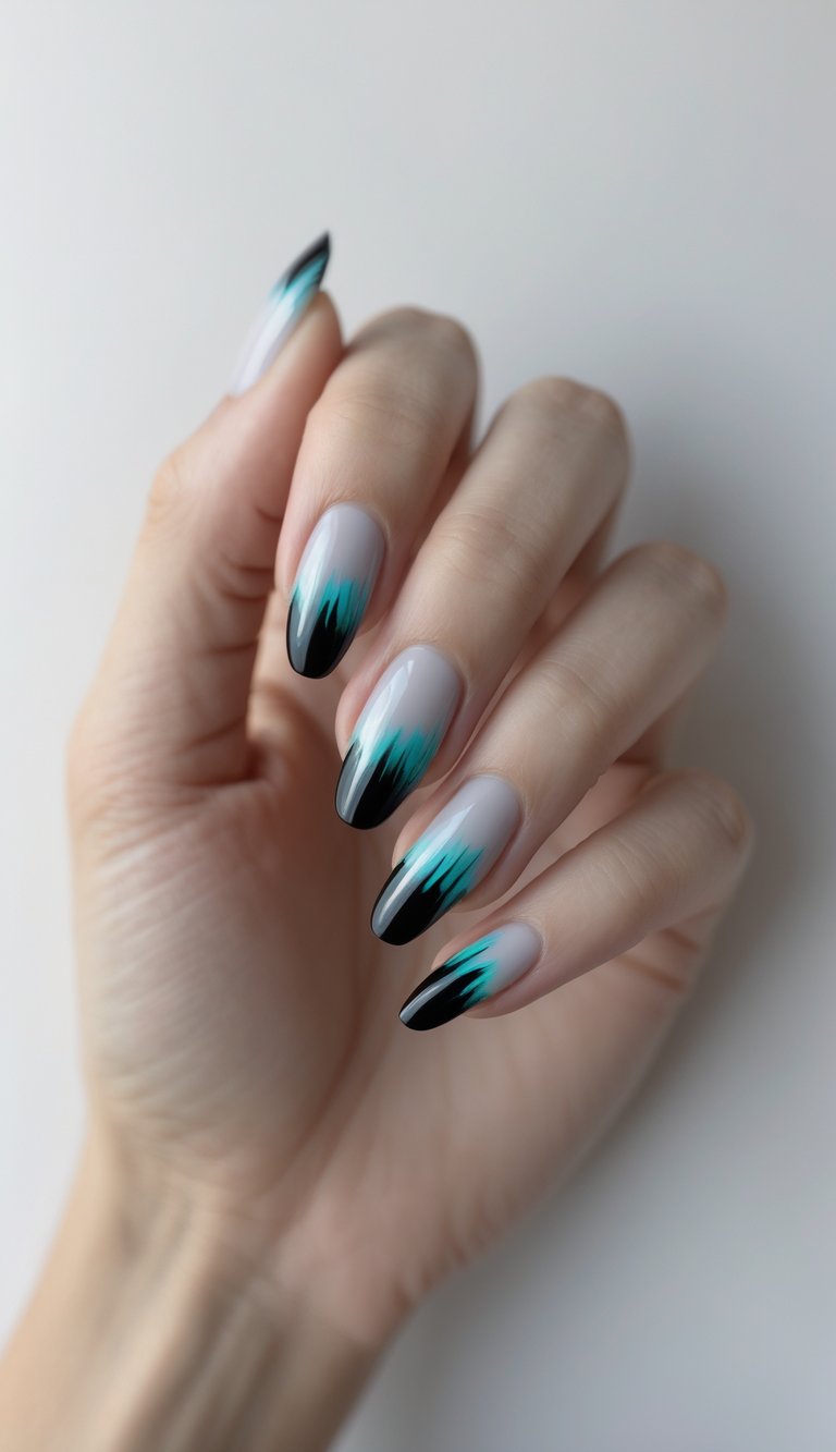 Close-up of one hand with black to gray ombre nails featuring aqua streaks against a white background.