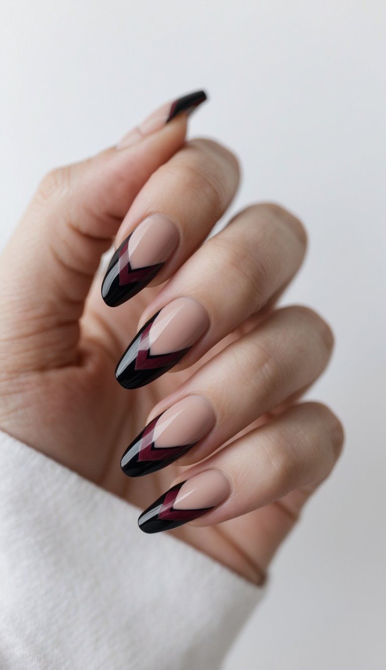 Close-up of a hand with black and burgundy French tip nails against a white background.