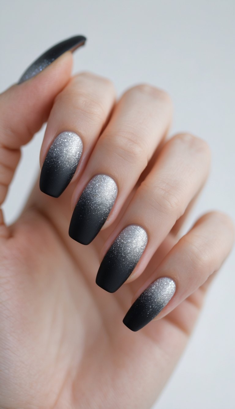 Close-up of a single hand with matte black nails featuring a subtle glitter gradient on a white background.