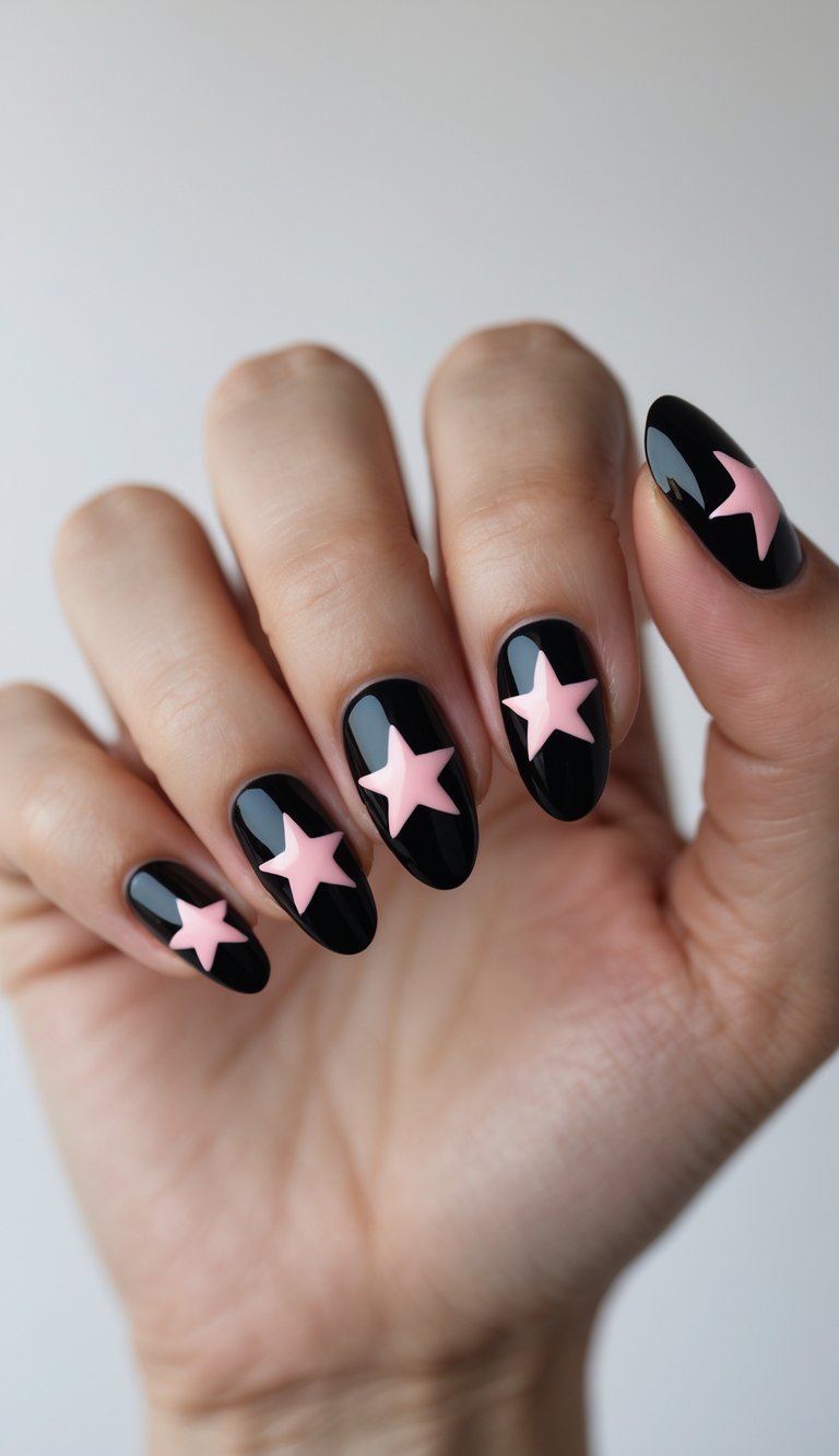Close-up of one hand with black nails decorated with pink star patterns against a white background.