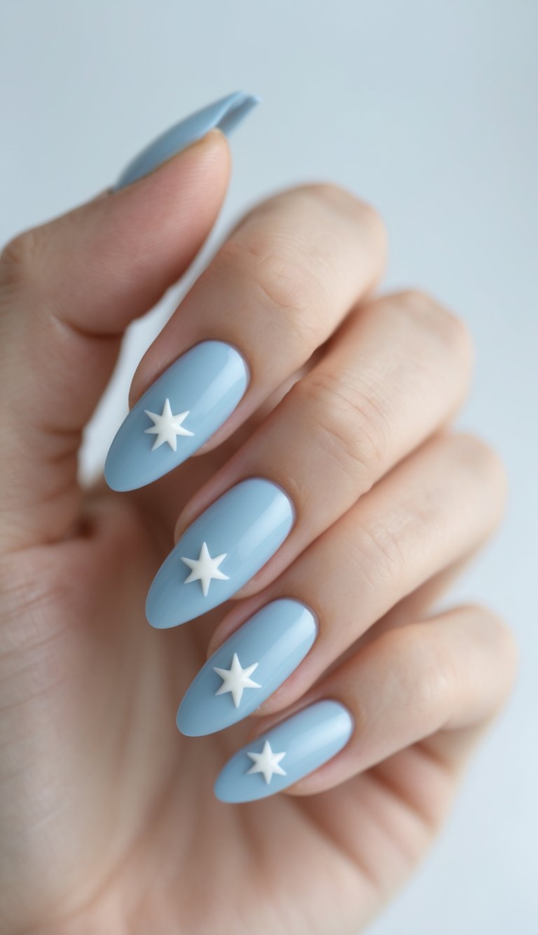 Close-up of one hand with powder blue nails decorated with simple star designs against a white background.