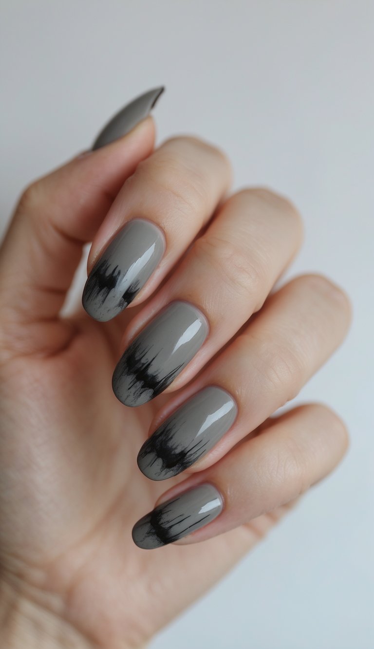 Close-up of one hand with charcoal-colored nails featuring smudged eyeliner-like nail art on a white background.