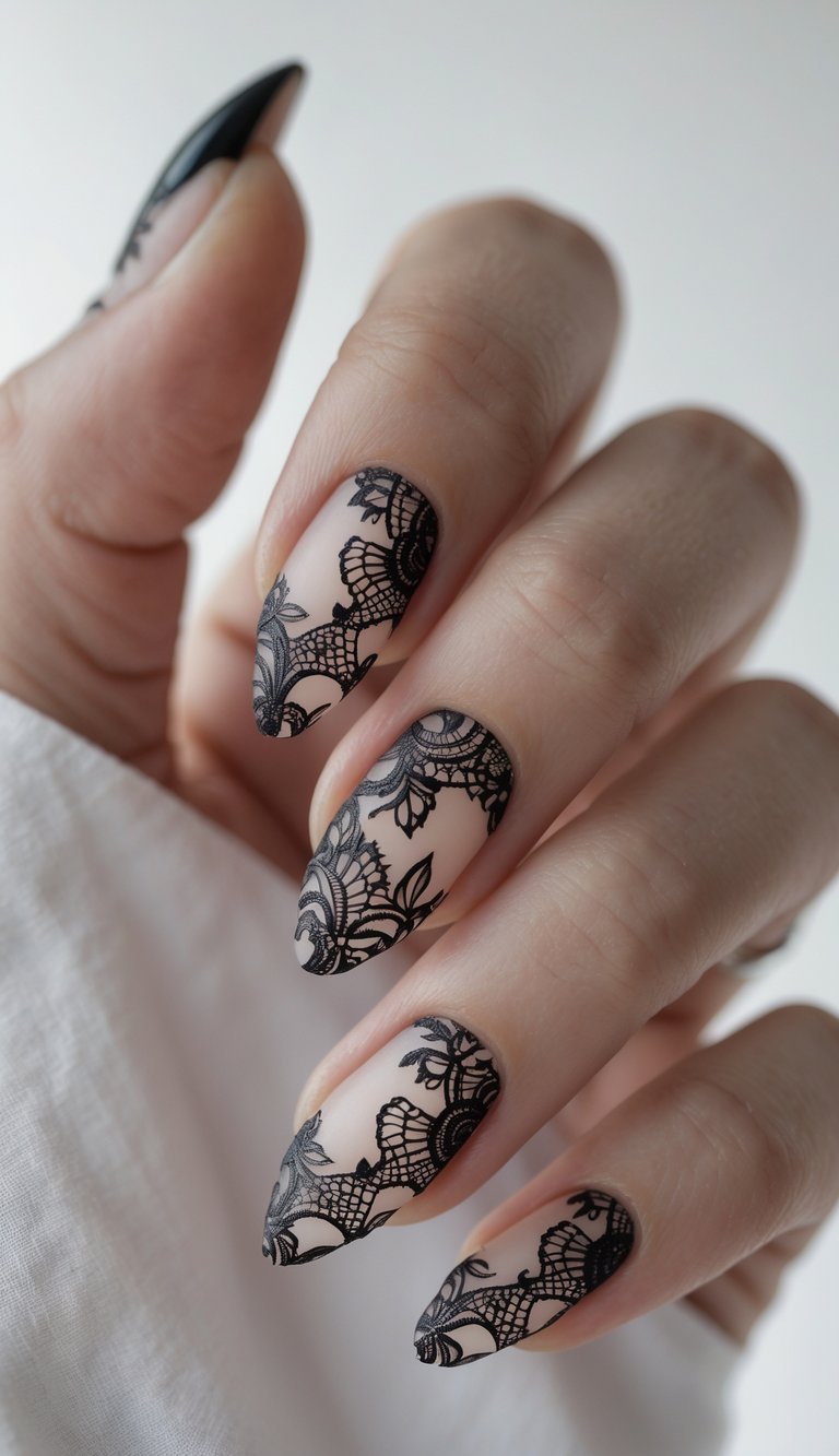 Close-up of one hand with black lace patterned nails against a white background.