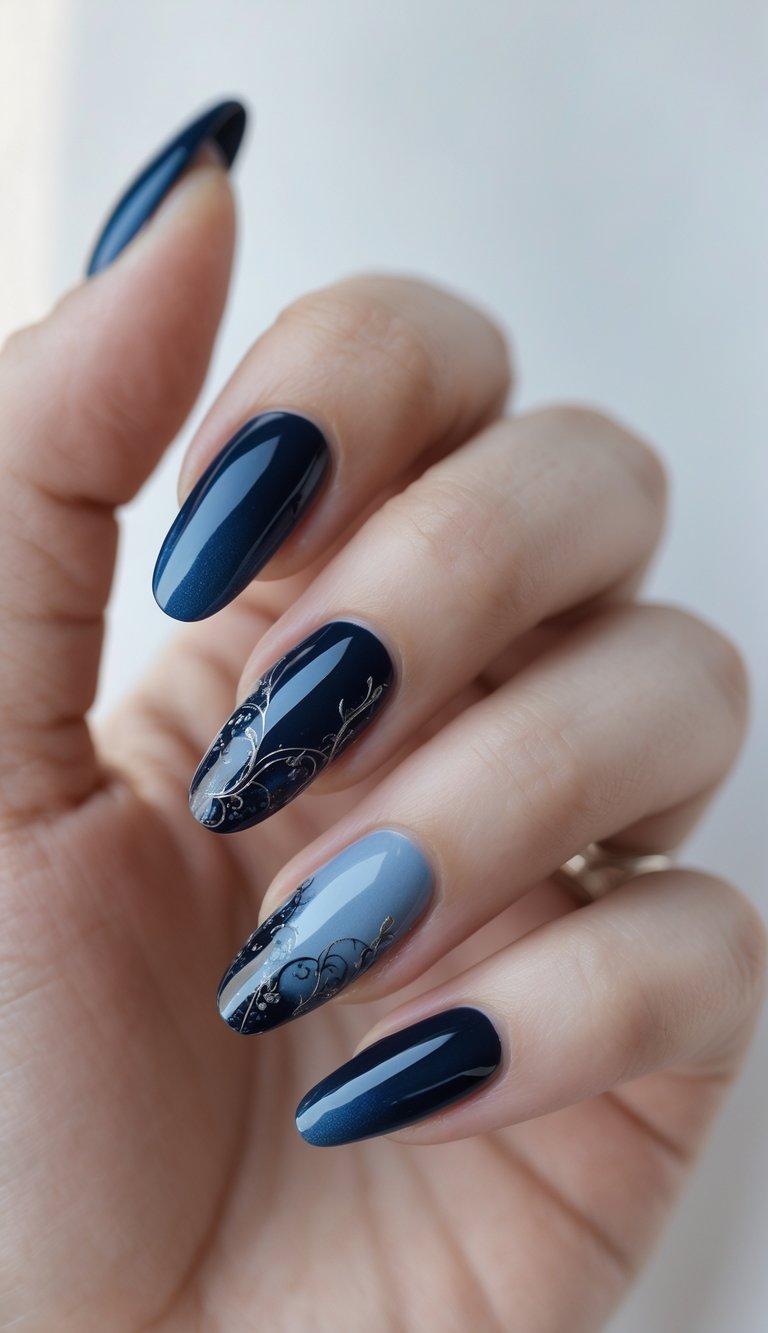 Close-up of one hand with dark blue gradient nails featuring detailed gothic-inspired designs against a white background.