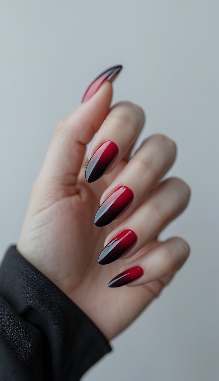 Close-up of one hand with blood-red gradient nails against a white background.
