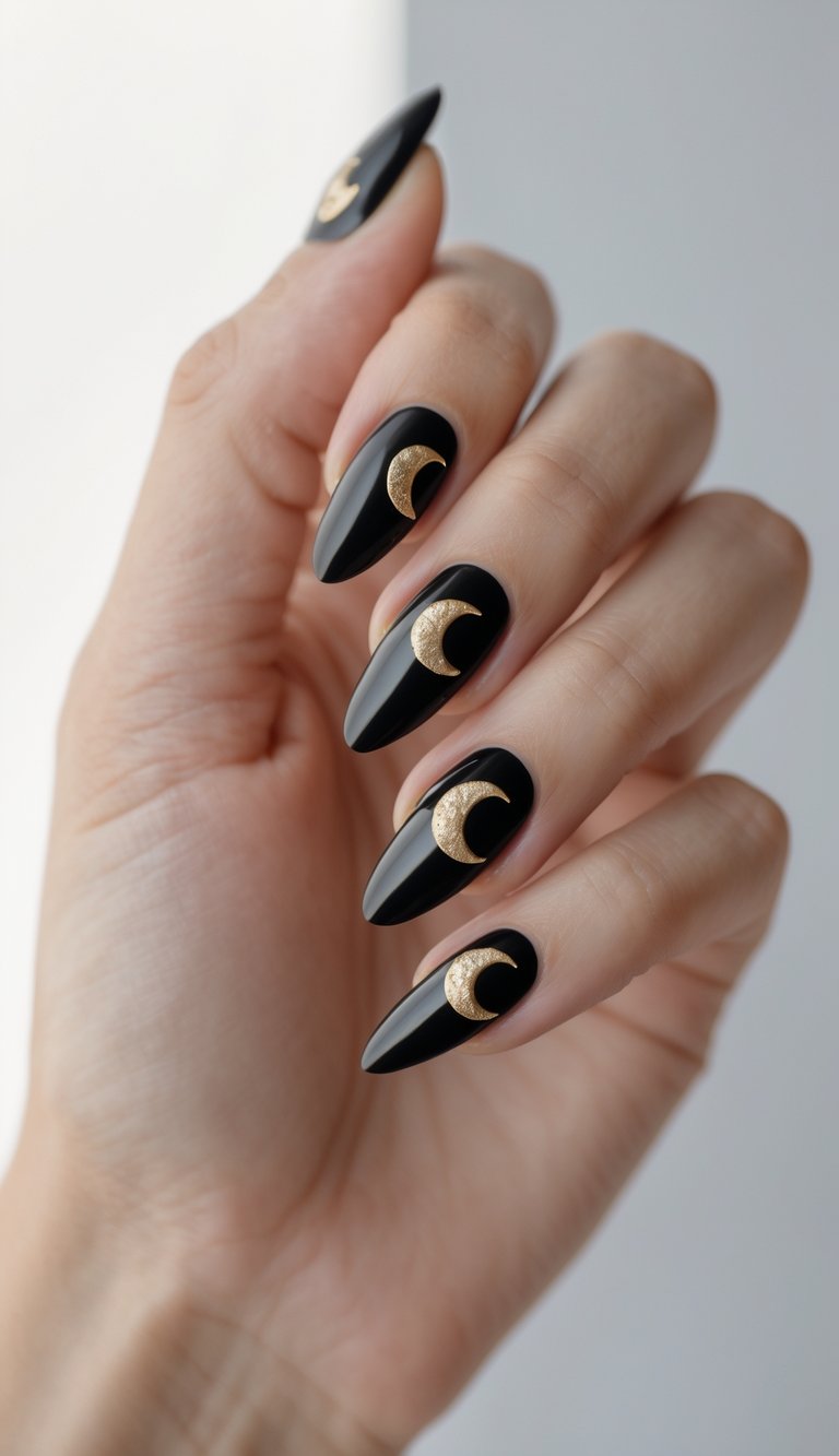 Close-up of one hand with black nails decorated with gold crescent moon designs against a white background.