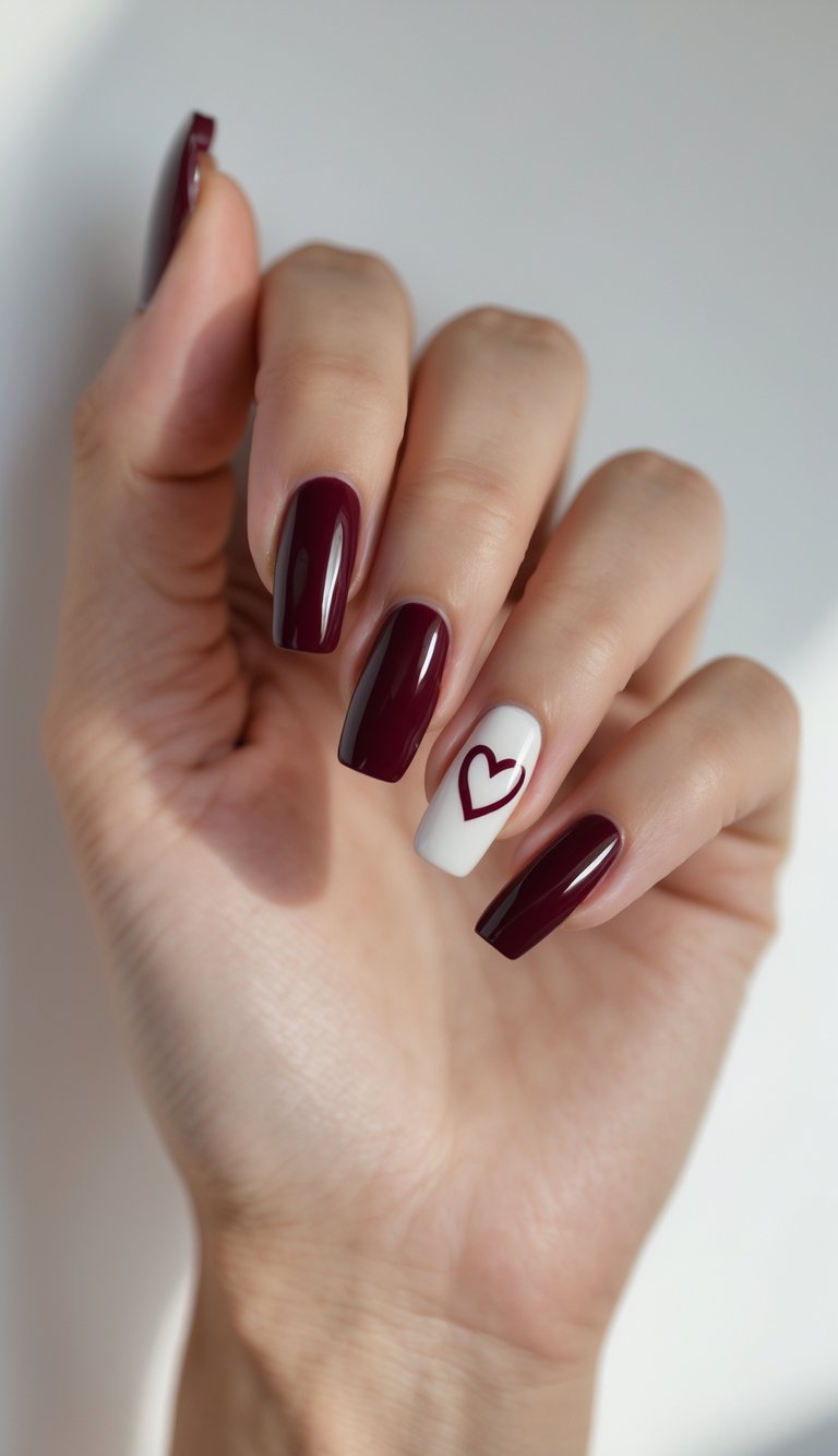 Close-up of a single hand with wine-red nails featuring small heart-shaped cutouts on a white background.