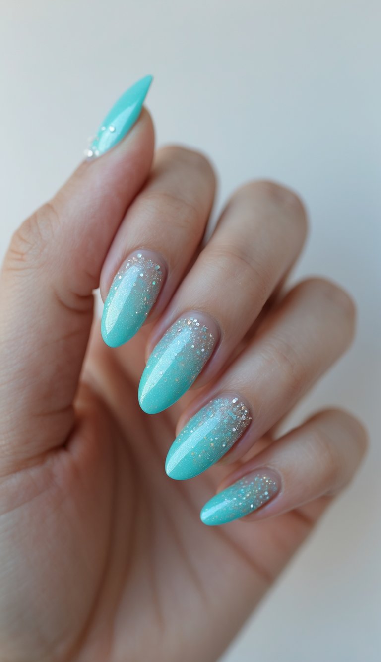 Close-up of one hand with aqua-colored nails featuring subtle glitter, against a white background.