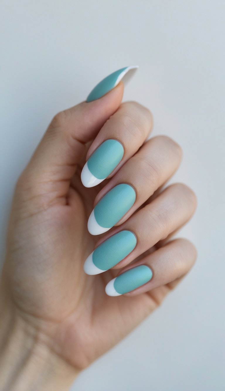 Close-up of one hand with aqua-colored nails featuring matte finish and glossy tips against a white background.