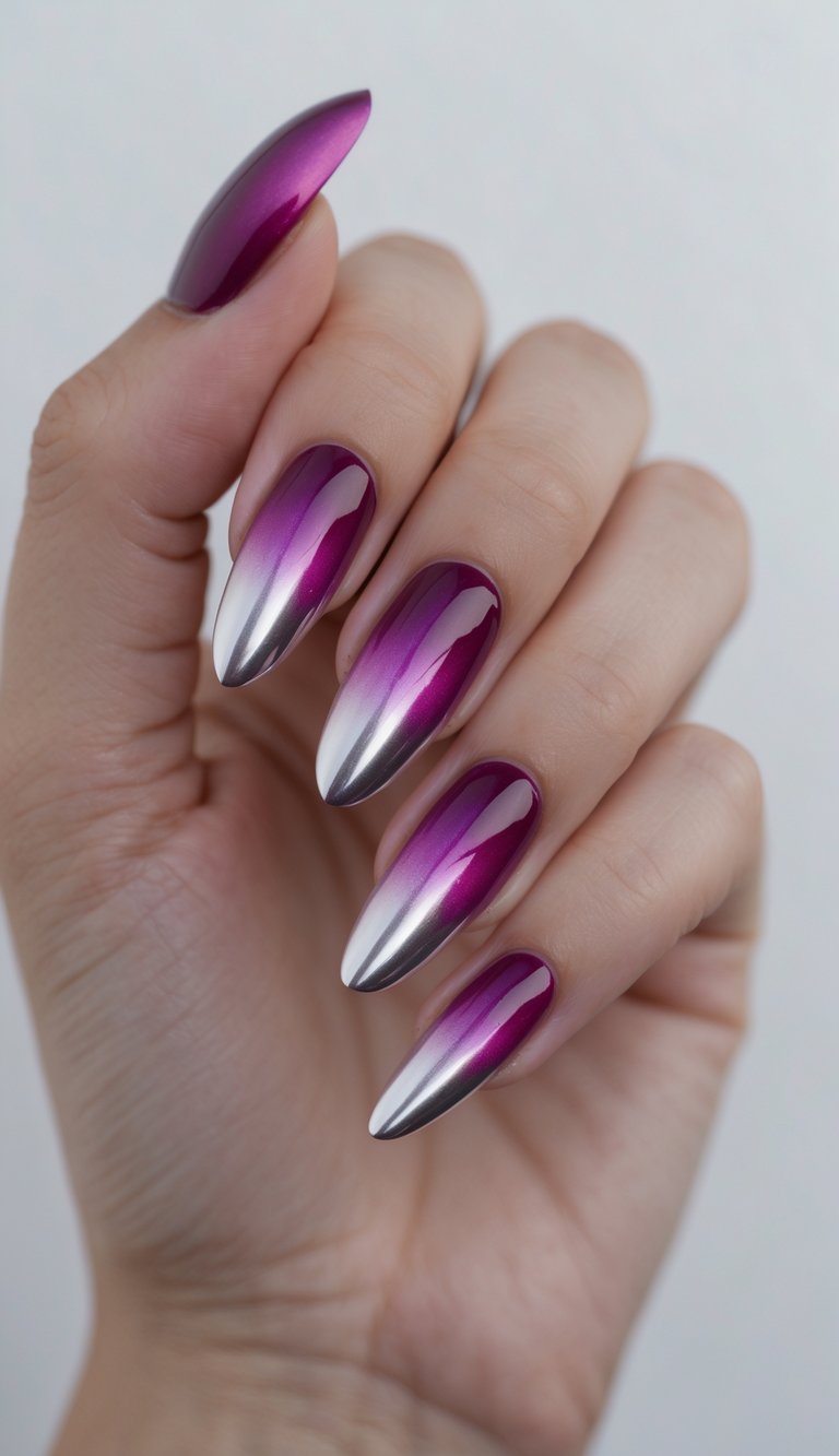 Close-up of one hand with magenta ombre nails and silver tips against a white background.