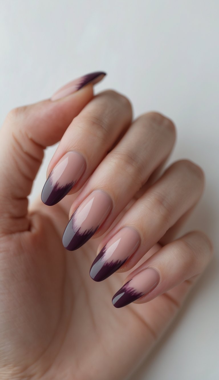 Close-up of one hand with neatly manicured nails featuring a plum-colored French manicure against a white background.