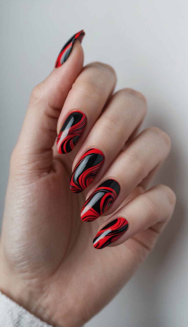 Close-up of one hand with red and black marble swirl nail art against a white background.
