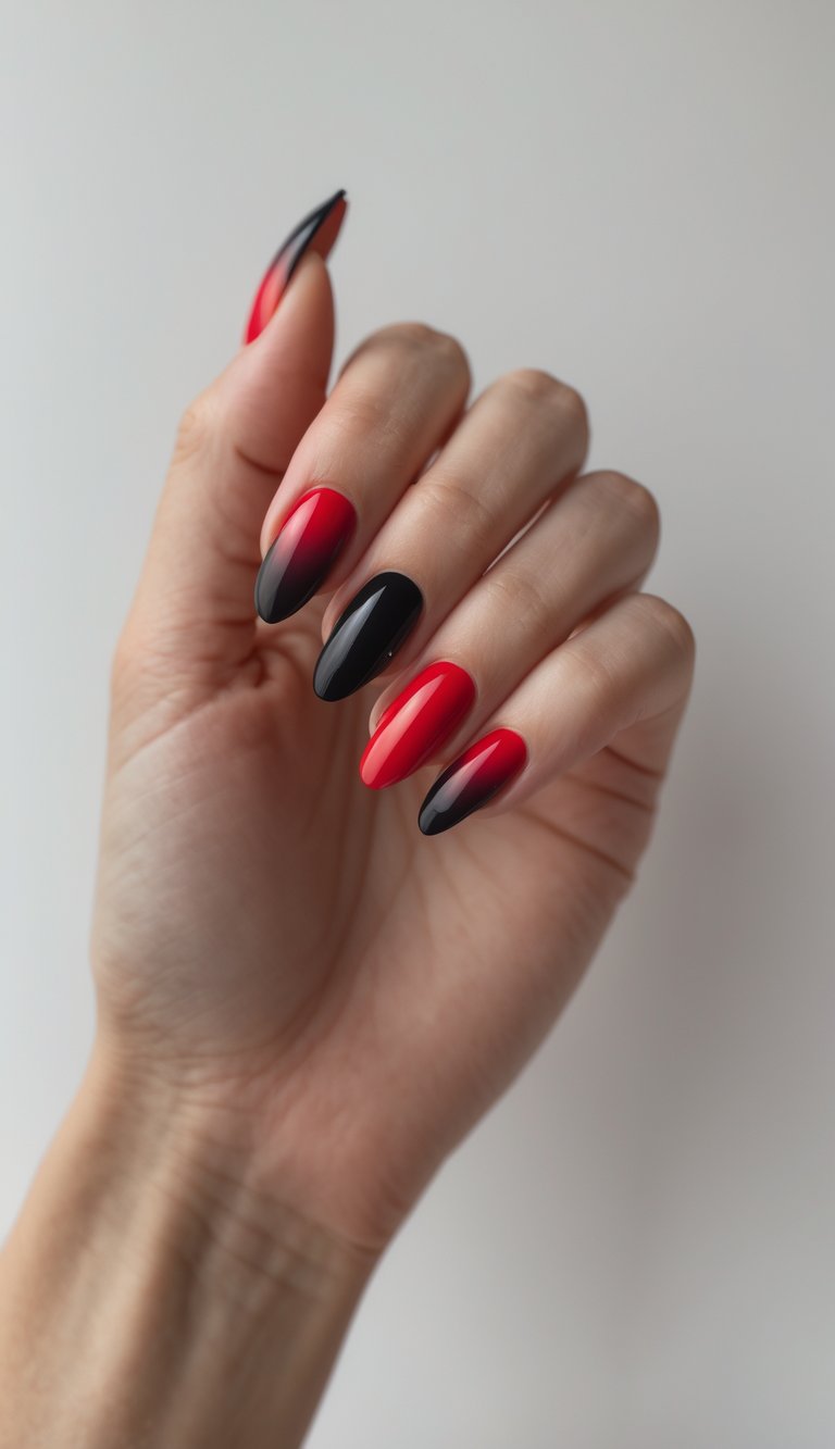 Close-up of one hand showing nails painted with a red to black ombre design against a white background.