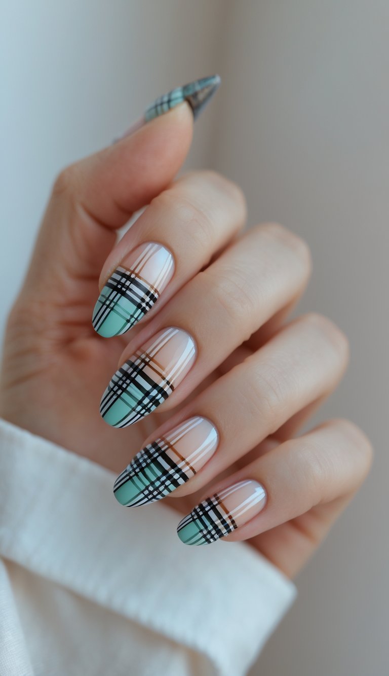 Close-up of a single hand showing nails with plaid ombre gradient nail art against a white background.