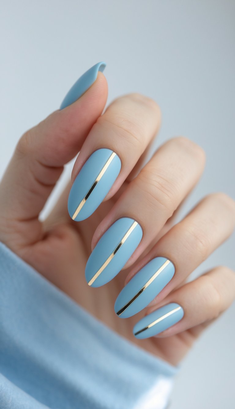 Close-up of one hand with baby blue matte nails featuring glossy stripes against a white background.