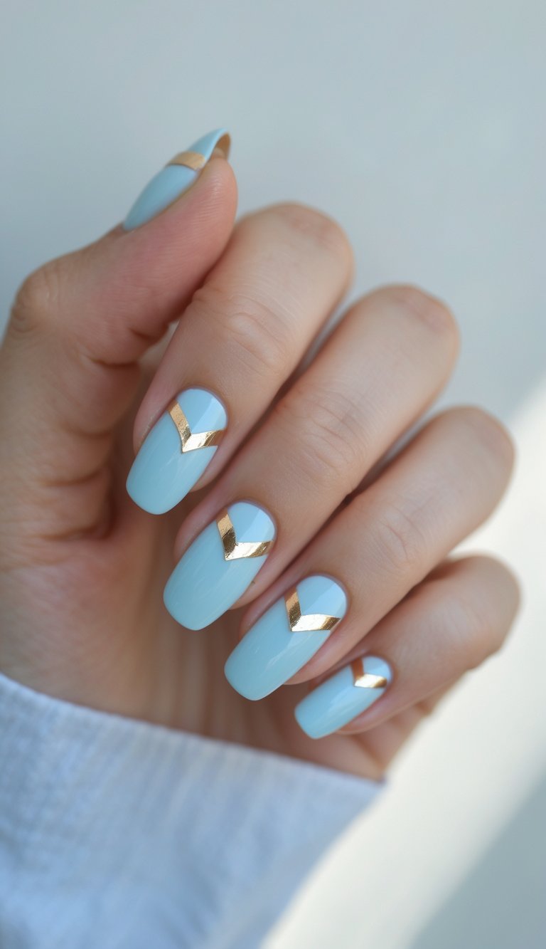Close-up of one hand showing baby blue nails with chevron foil accents on a white background.