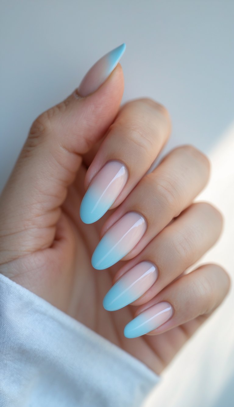Close-up of one hand with baby blue French tip nails against a white background.