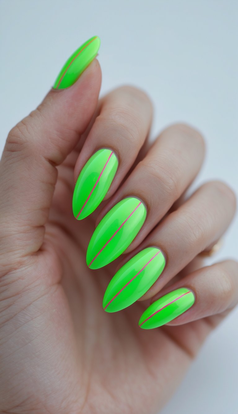 Close-up of one hand with neon green almond-shaped nails and thin neon red lines on a white background.