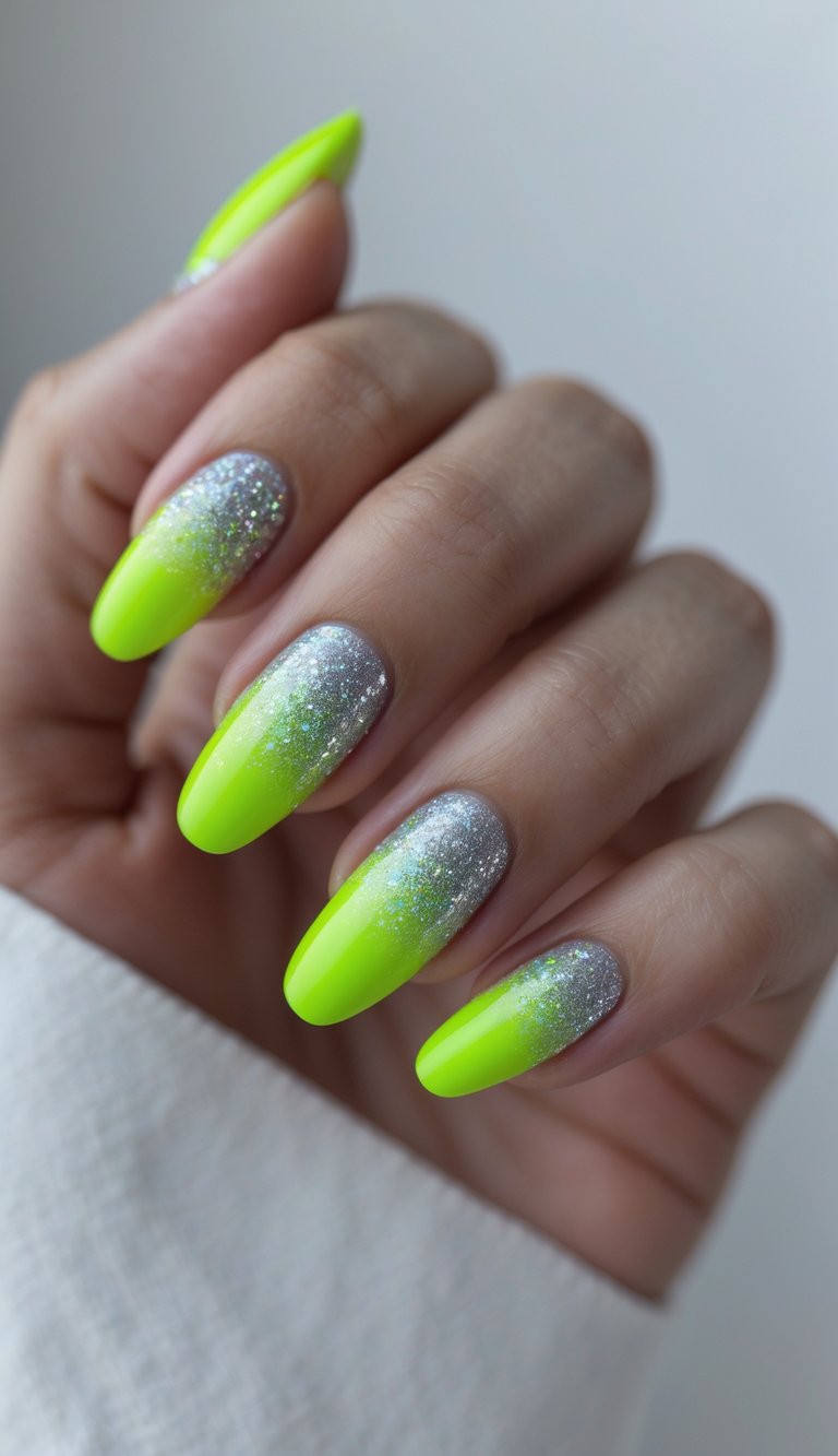 Close-up of one hand showing neon green nails with silver glitter gradient on a white background.