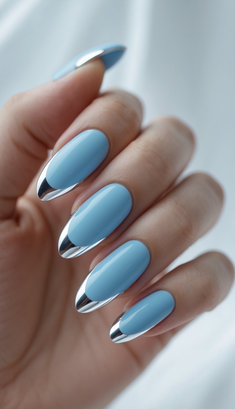 Close-up of one hand with sky blue nails and silver tips against a white background.