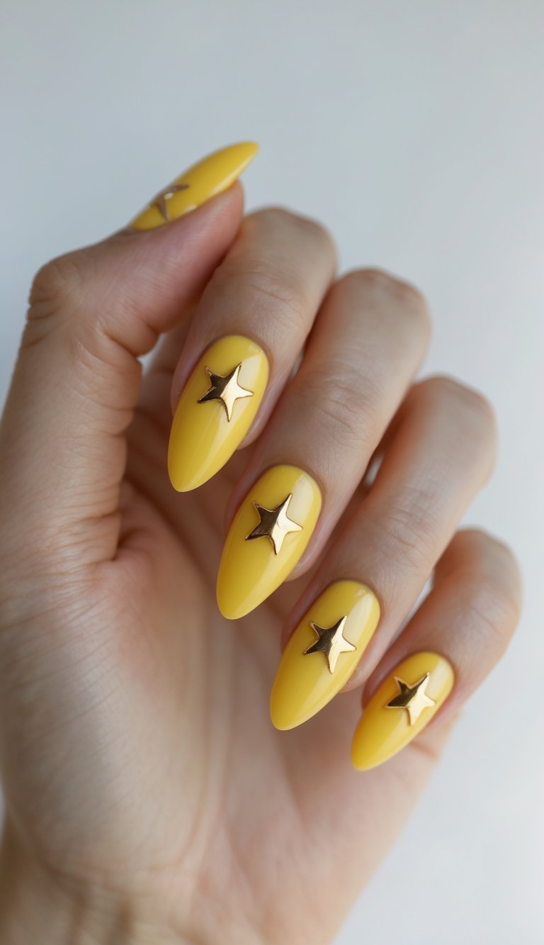 Close-up of one hand showing yellow almond-shaped nails decorated with small gold stars on a white background.