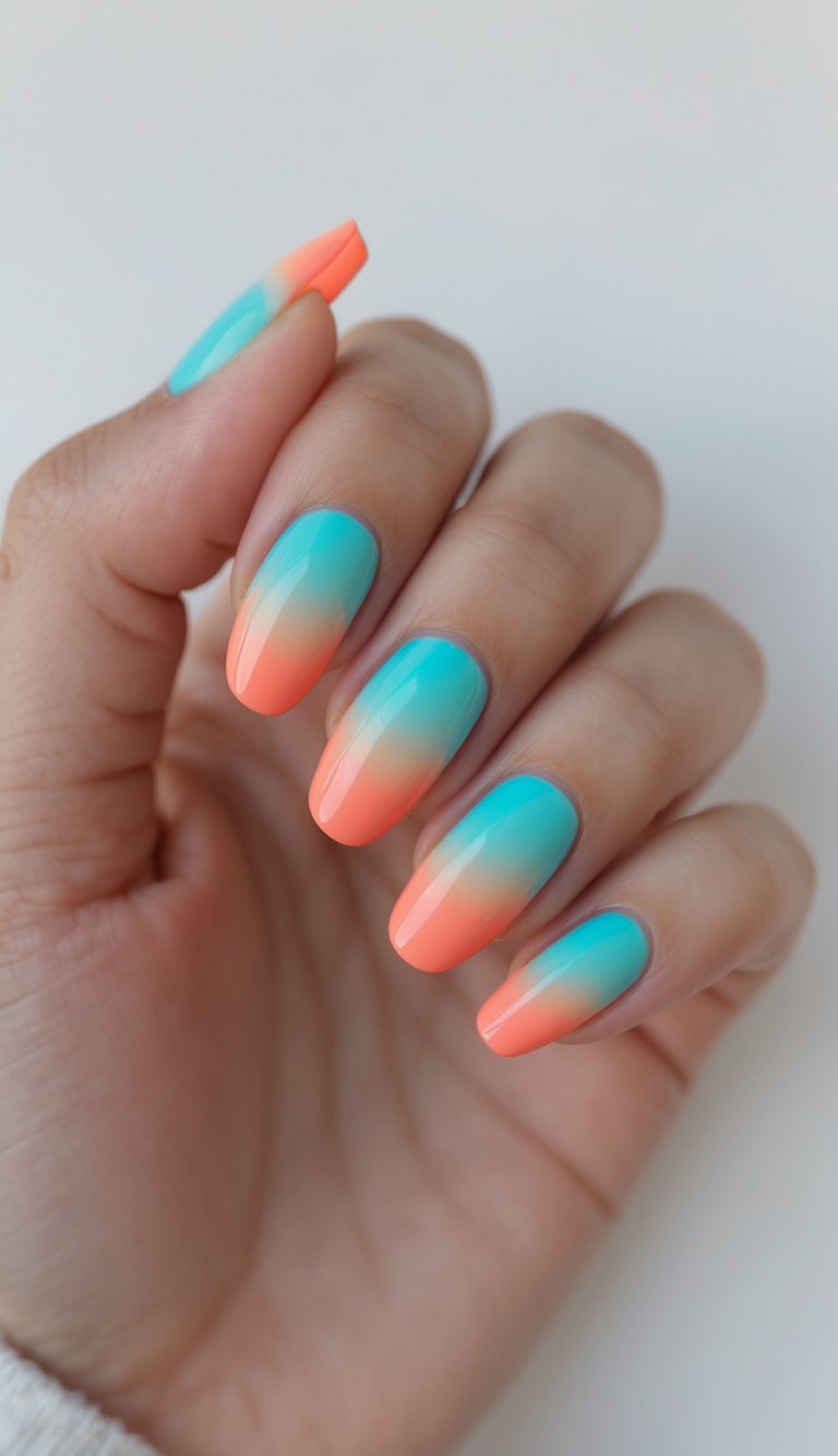 Close-up of one hand with turquoise and coral ombre nails against a white background.