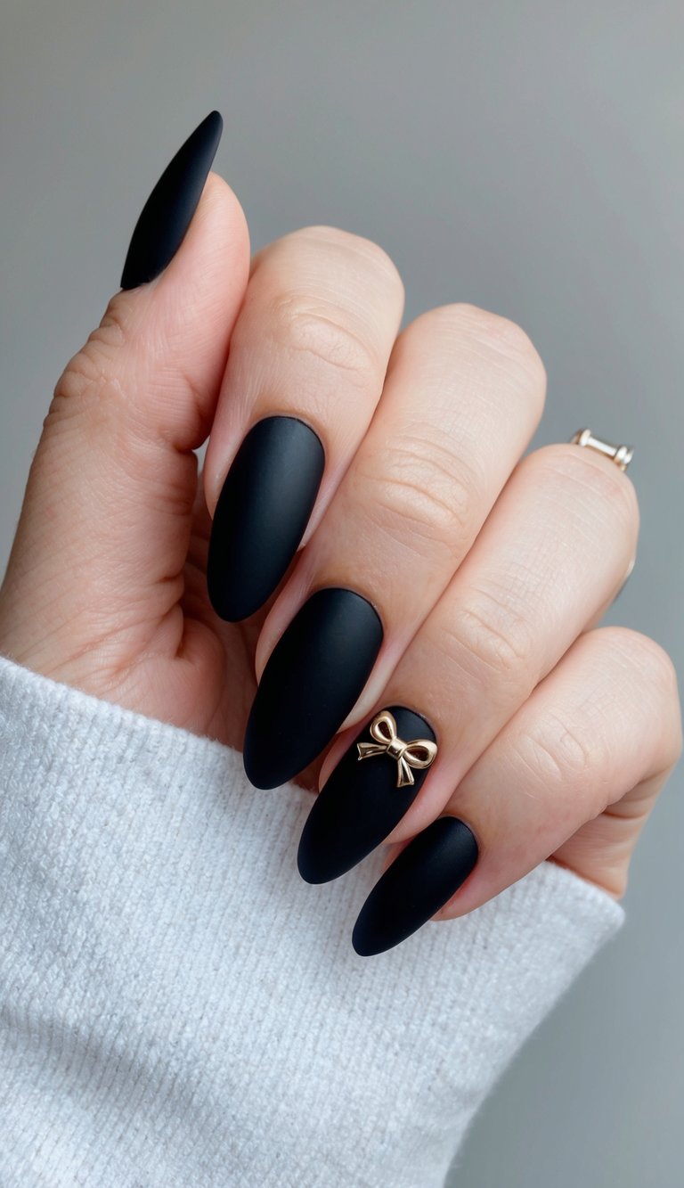 A sleek, matte black nail with a charming bow accent