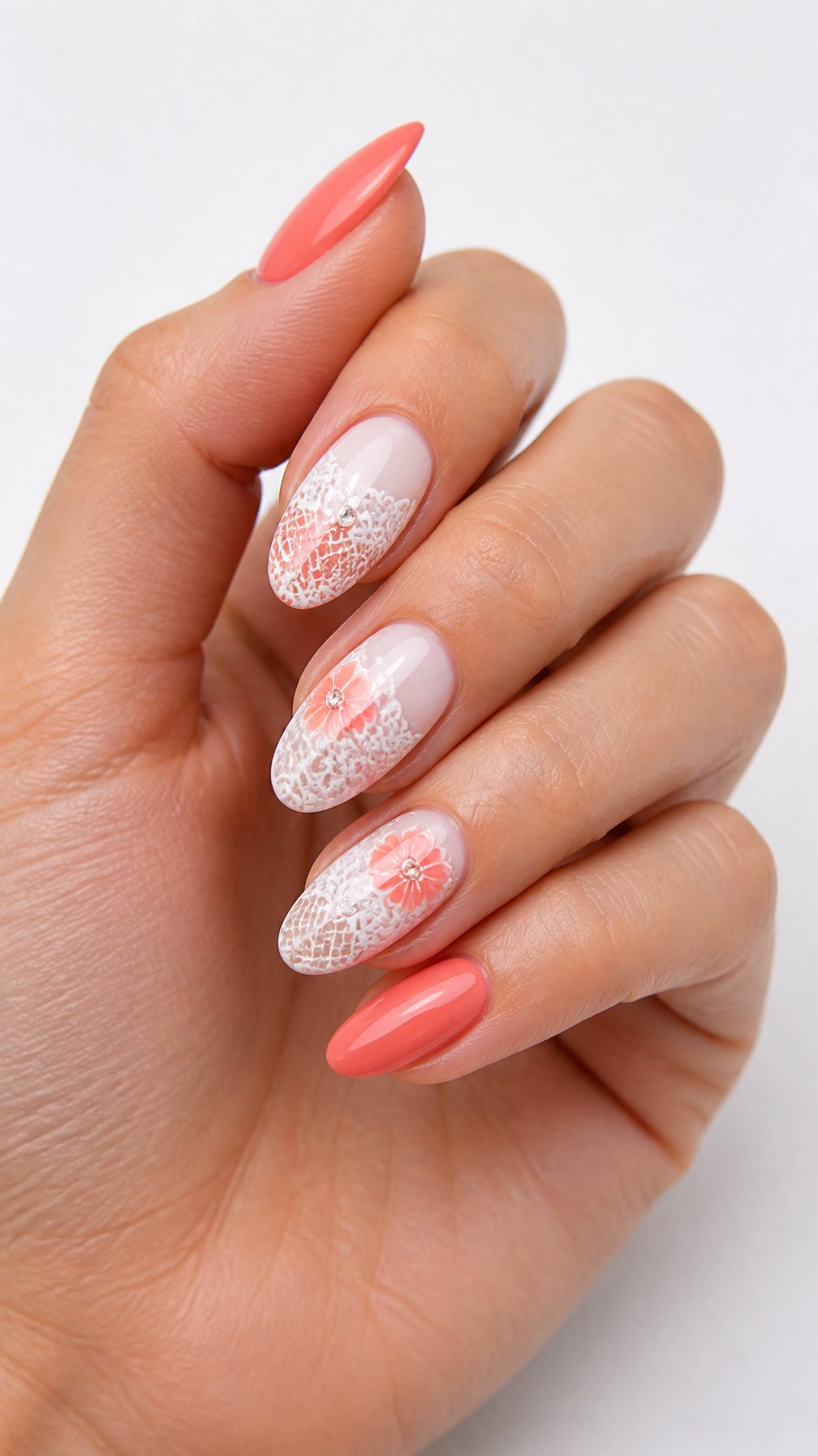 A single hand with glossy coral and white lace-patterned manicured nails against a white background.