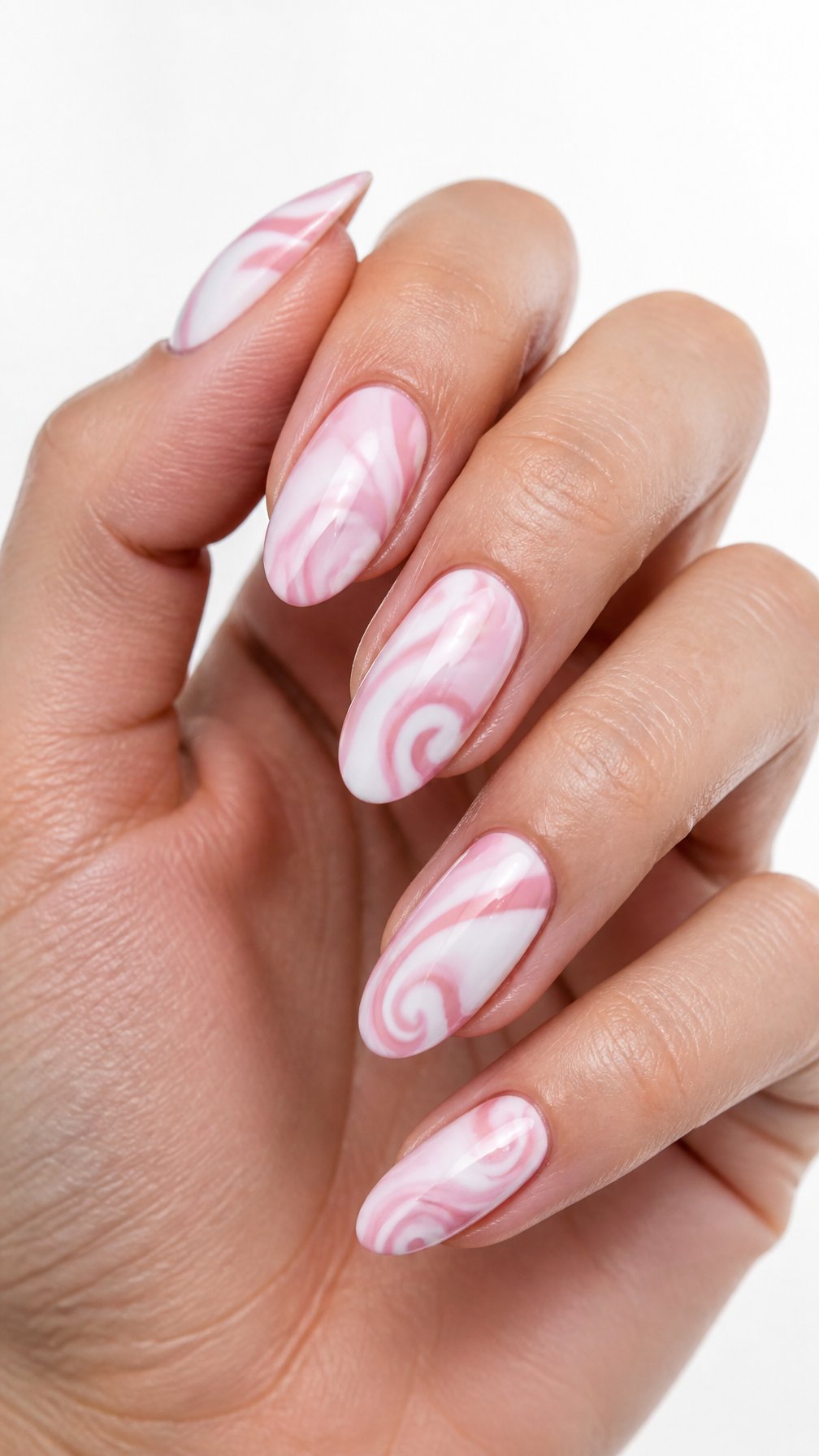 A single hand with glossy pink-and-white swirl designs on almond-shaped nails against a white background.