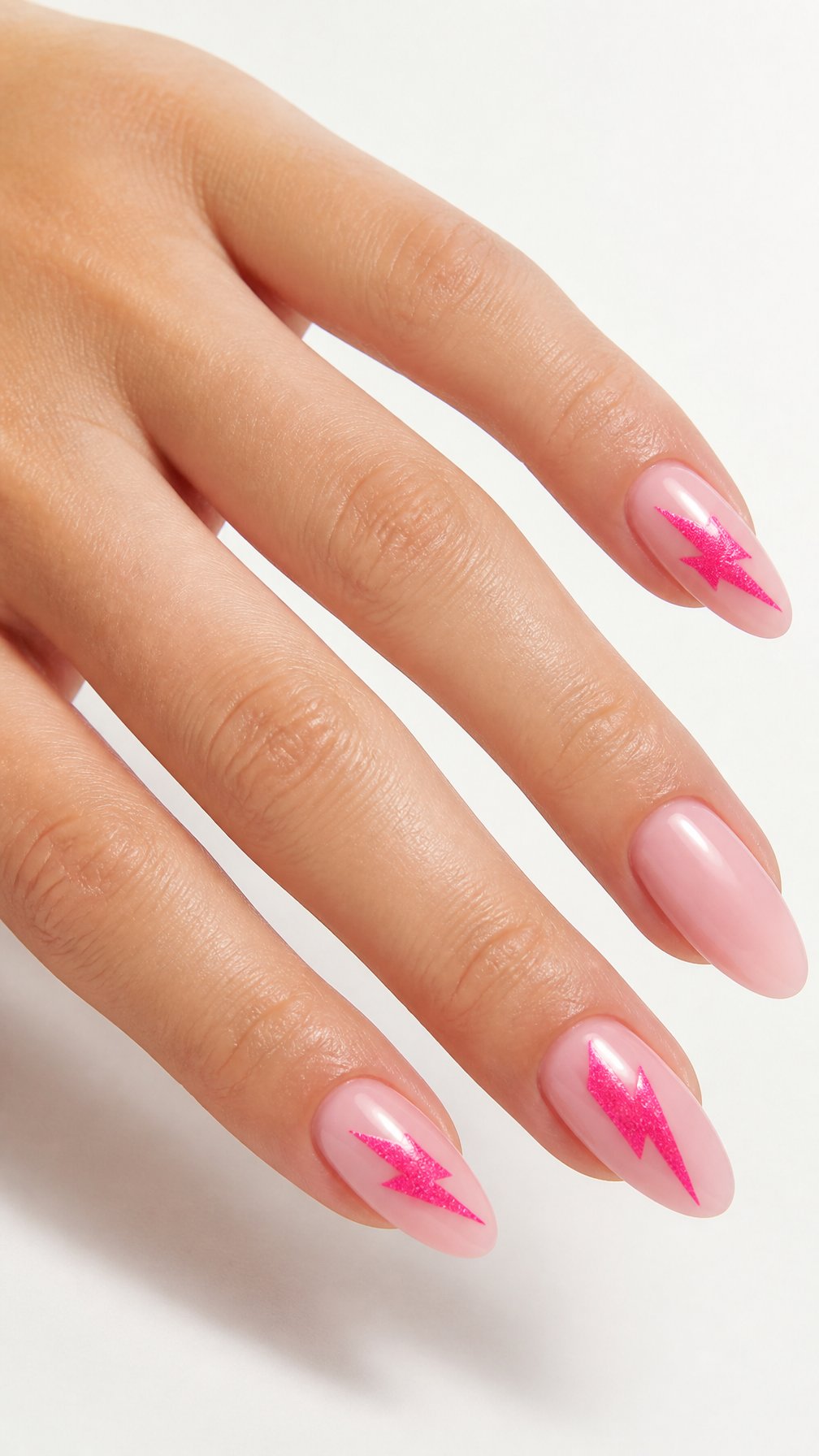 A single hand with glossy blush-pink nails decorated with hot-pink lightning bolts against a white background.