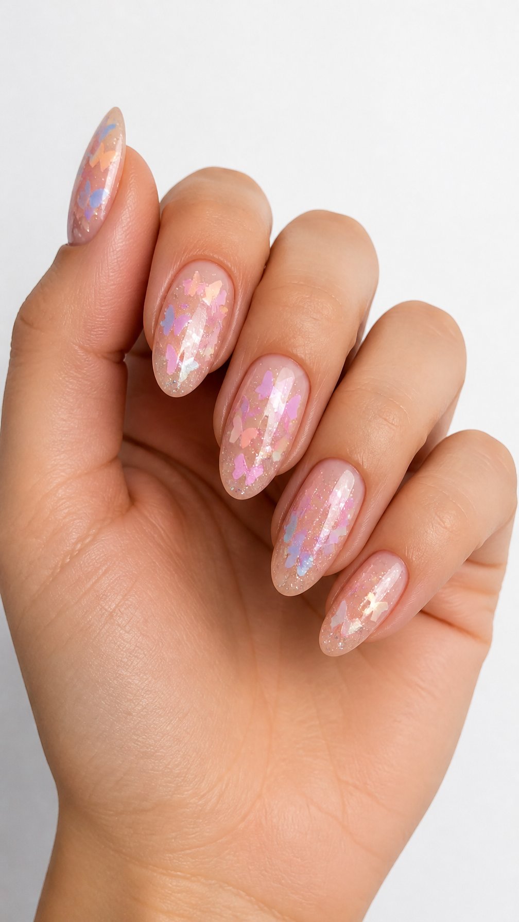 A single hand with glossy pastel butterfly glitter nail art on a white background.